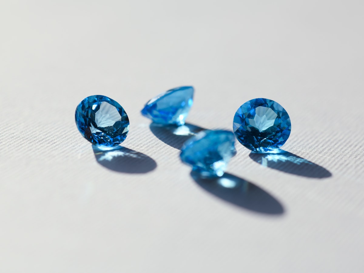 Loose faceted blue sapphire gemstones on a white background