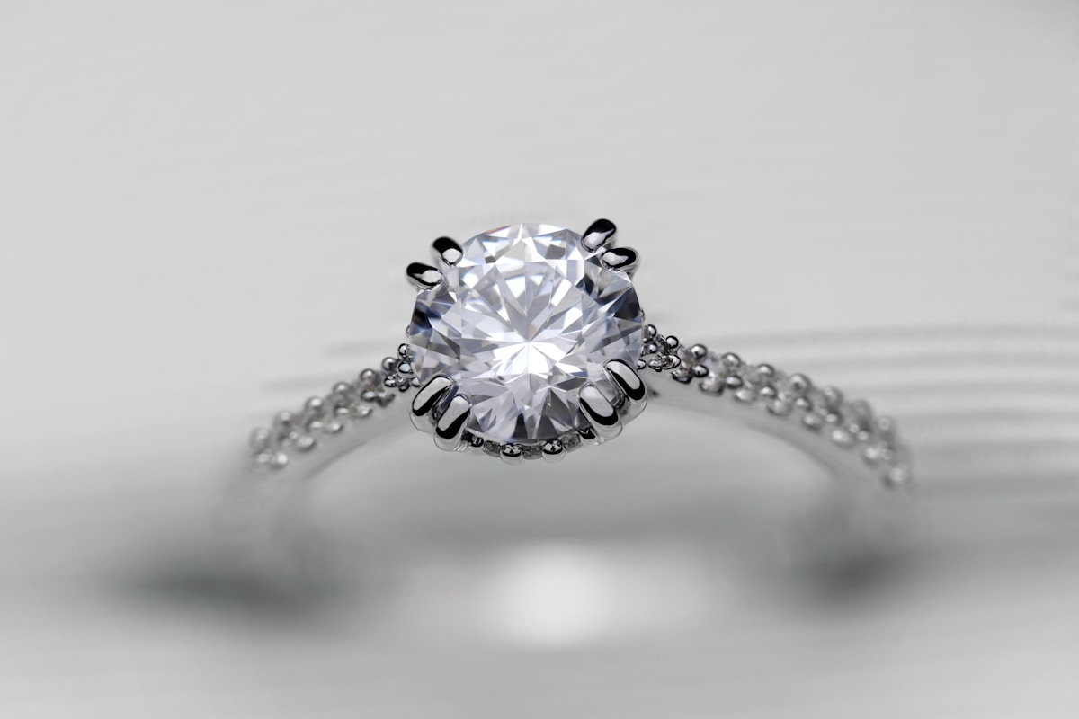 A yellow gold engagement ring with an emerald-cut diamond
