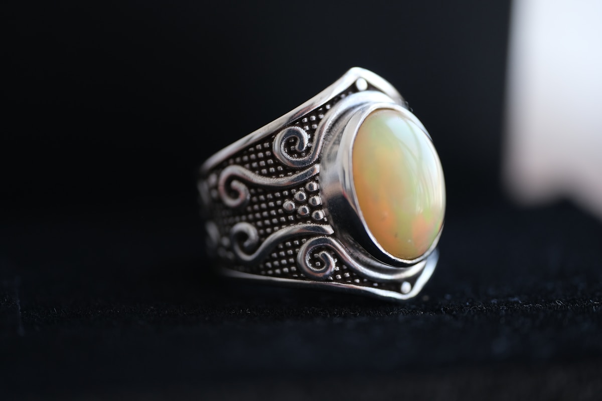 A close-up of an opal ring showing its iridescent color play